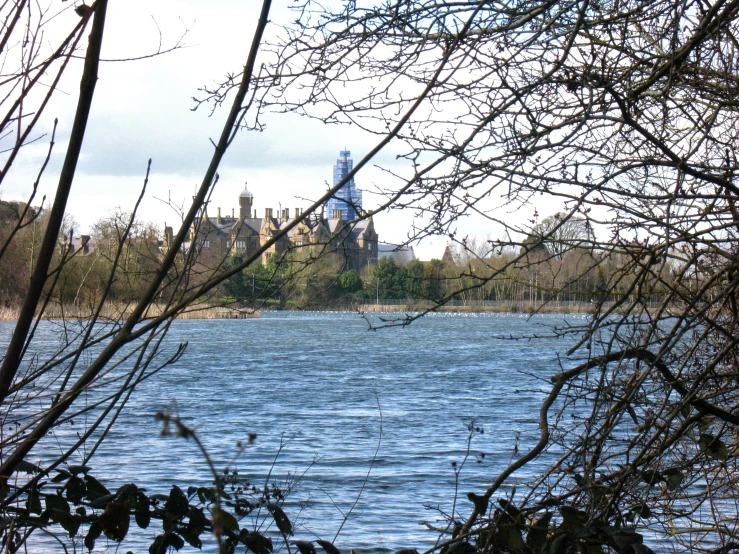 a castle is behind a body of water