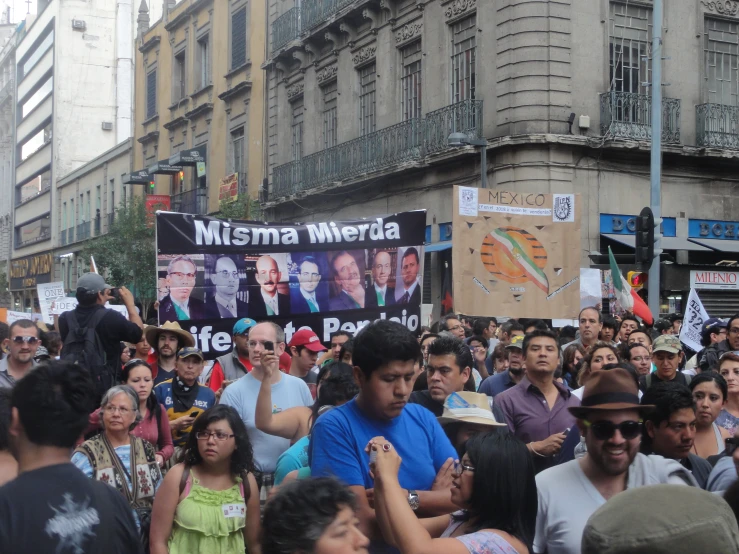 a group of people with signs and flags in front of them