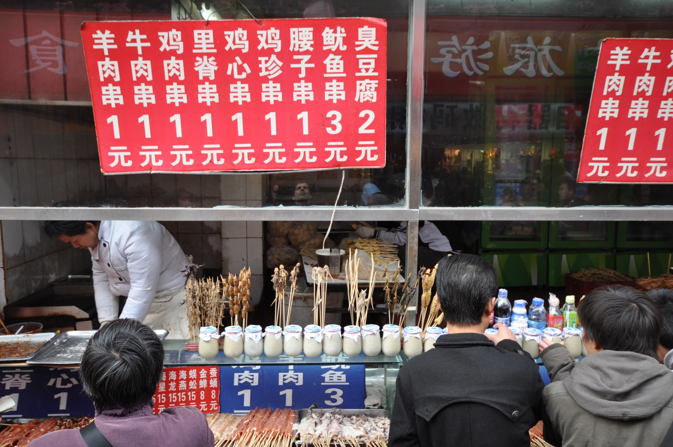 a crowd of people looking at food on display