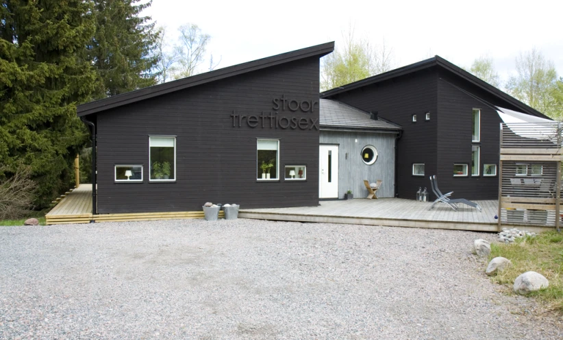 a black building with two bicycles sitting in front of it