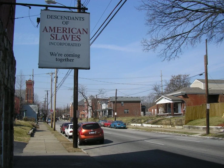 an image of sign advertising a museum on a street