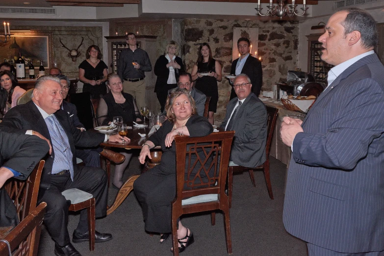 a group of people seated at tables in a restaurant