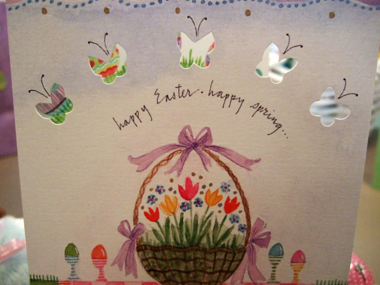 a greeting card decorated with a basket with flowers