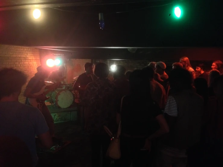 a group of people standing around a bar together