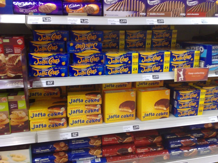 a store shelf full of various kinds of cakes