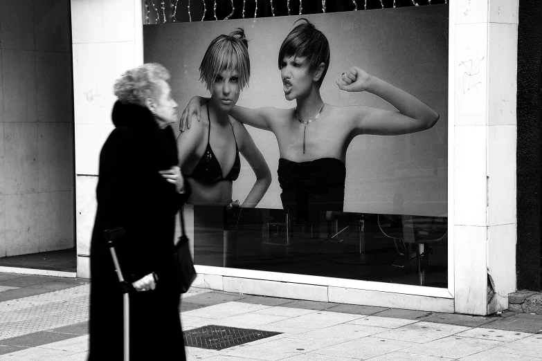 black and white po of a woman looking at a store window