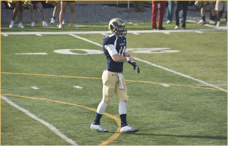 a player on the sideline preparing for a football