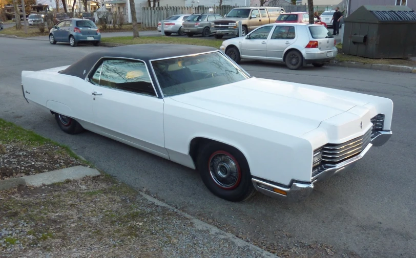 a white car parked in the middle of a street