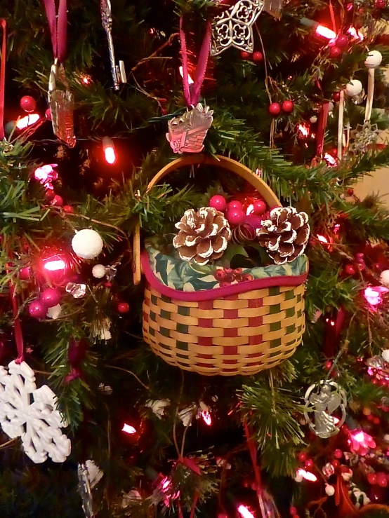 a basket on top of a tree with ornaments