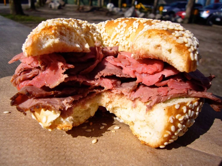 a corned beef and cheese bagel cut in half