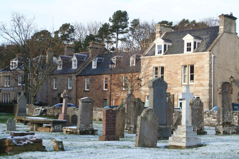 old cemetery with a brick building in the background