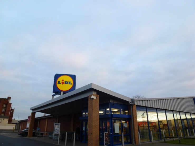 a store with a large, blue roof and the sign for a big 4