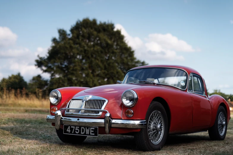 an old car parked in a grassy field