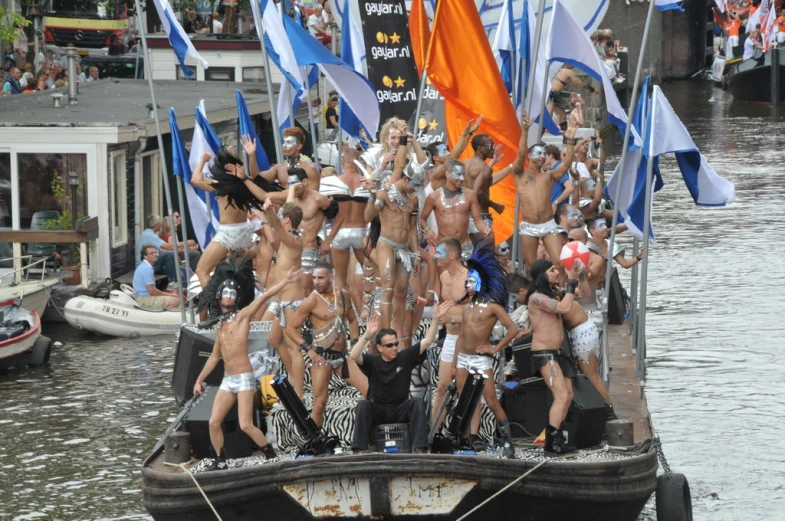 people in white bathing suits are standing on a boat