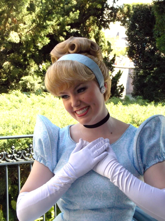 a woman wearing a blue dress with a white glove