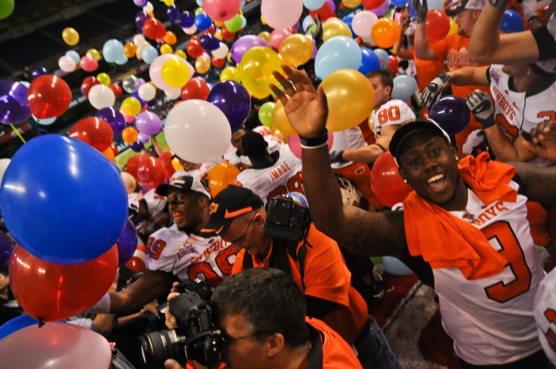 a group of people in uniforms holding balloons