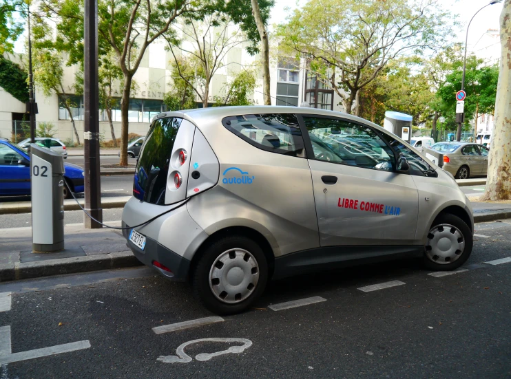 an unusual car is parked on the side of a street