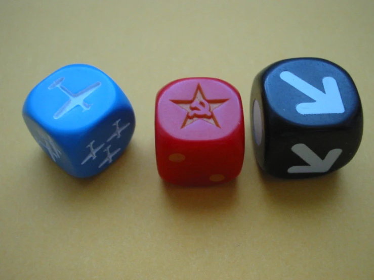 three dices with various symbols on them laying next to each other