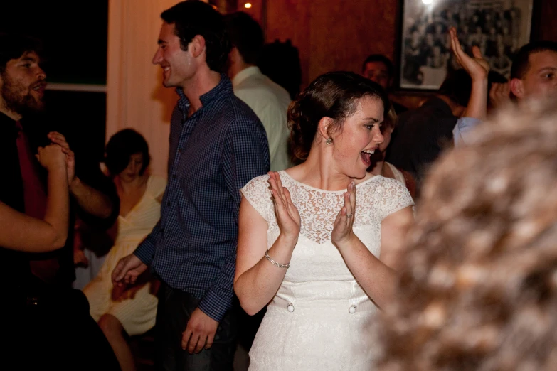 a wedding guest clapping during the dance