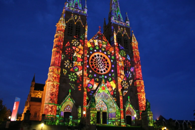 large colorful lite up church during the evening