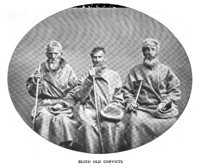 a group of four old men pose for a picture