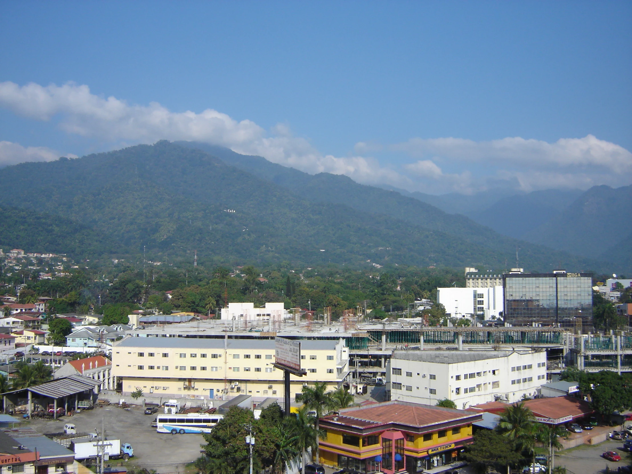 cityscape with mountains and buildings on both sides