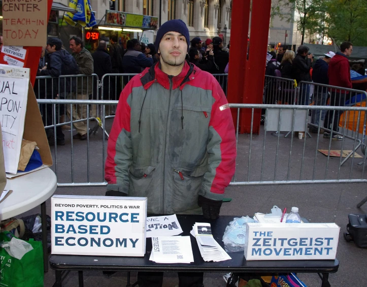 a man is standing in front of a table full of signs