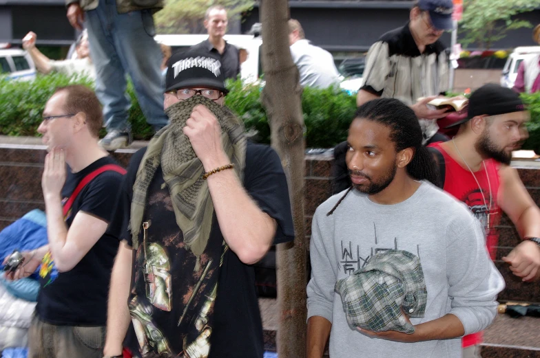 two men are standing in the crowd on a city street