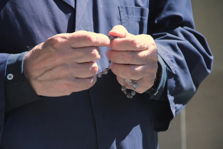 a person wearing a suit and holding soing on their fingers