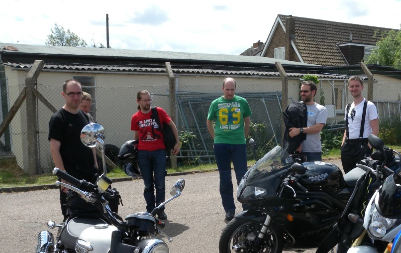 a group of bikers posing for a po