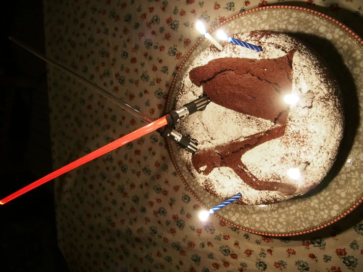 cake sitting on a plate with a straw stick sticking out of it