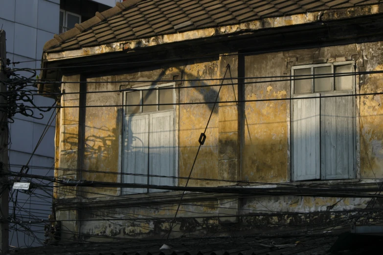 an old building with some broken windows on the side of it