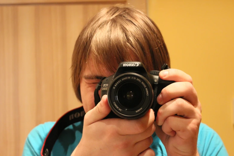 a man holds up his camera to take a po