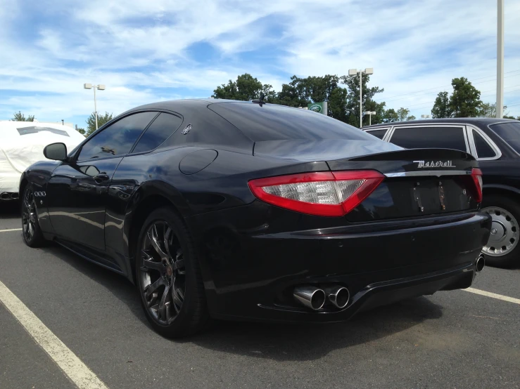 a black sports car with its roof open