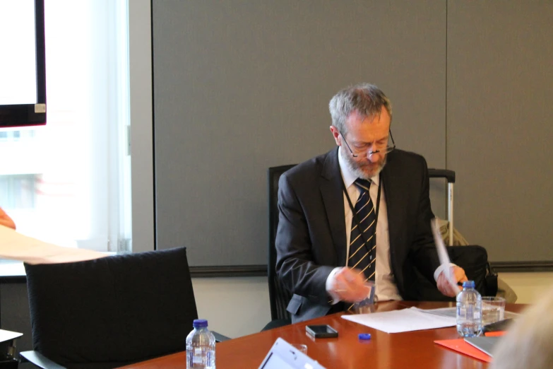 a man in a suit is at a table