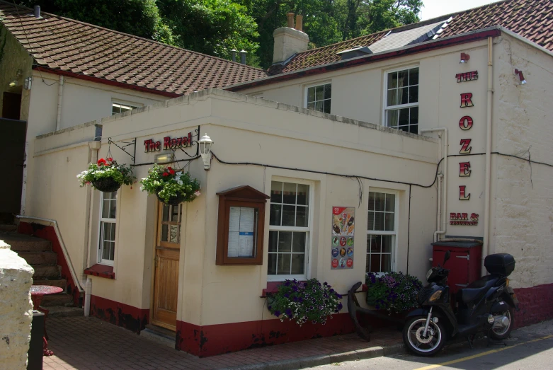 a motor cycle is parked in front of a large white building