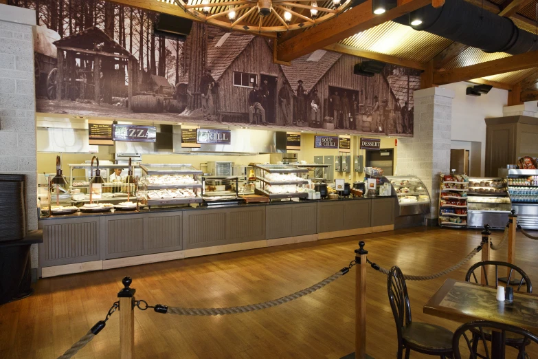 a bakery inside a building with wooden floors and counters