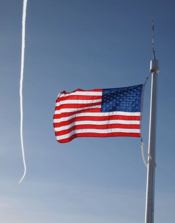 the american flag flies high in the sky