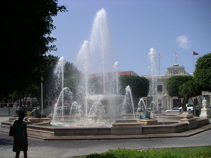 a large water fountain near a plaza in a city