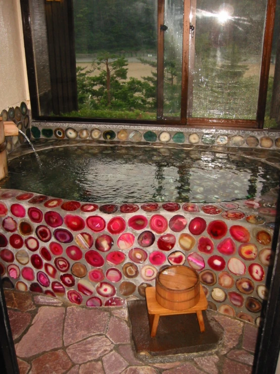 a wooden chair sitting in the middle of a round pool