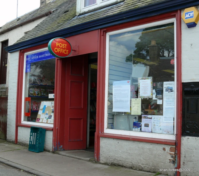 the shop front has a red door