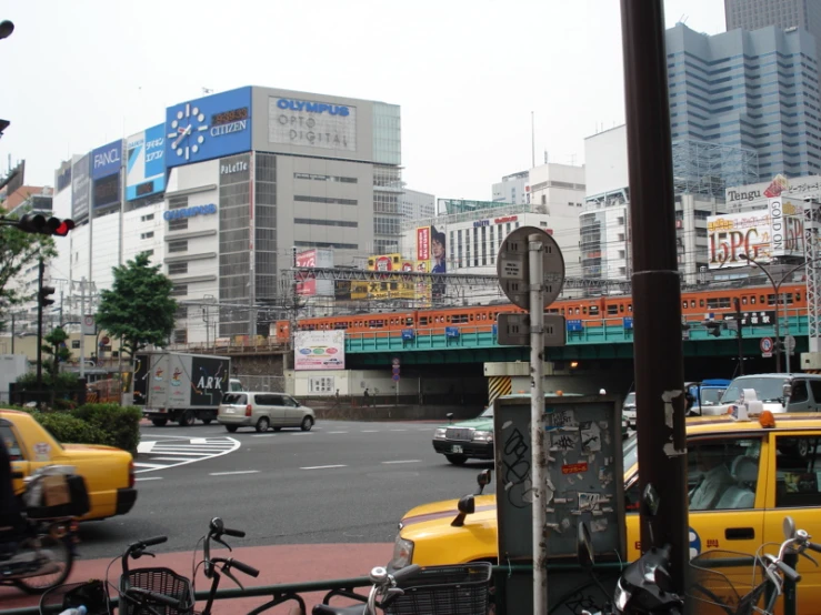 a busy street with cars and bicycles parked at the curb