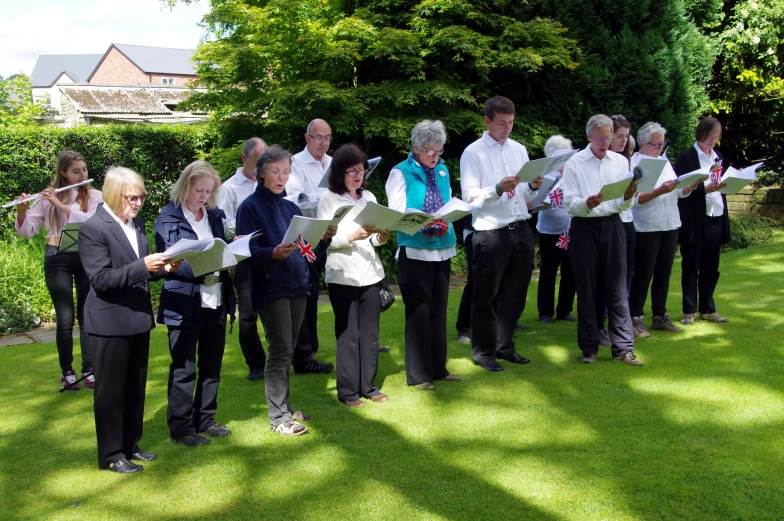 there are people that are standing together and holding papers