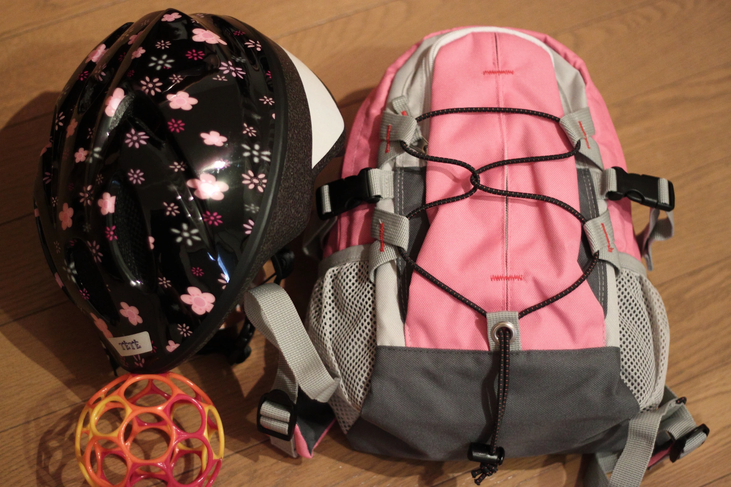 two helmets and one bag on the ground