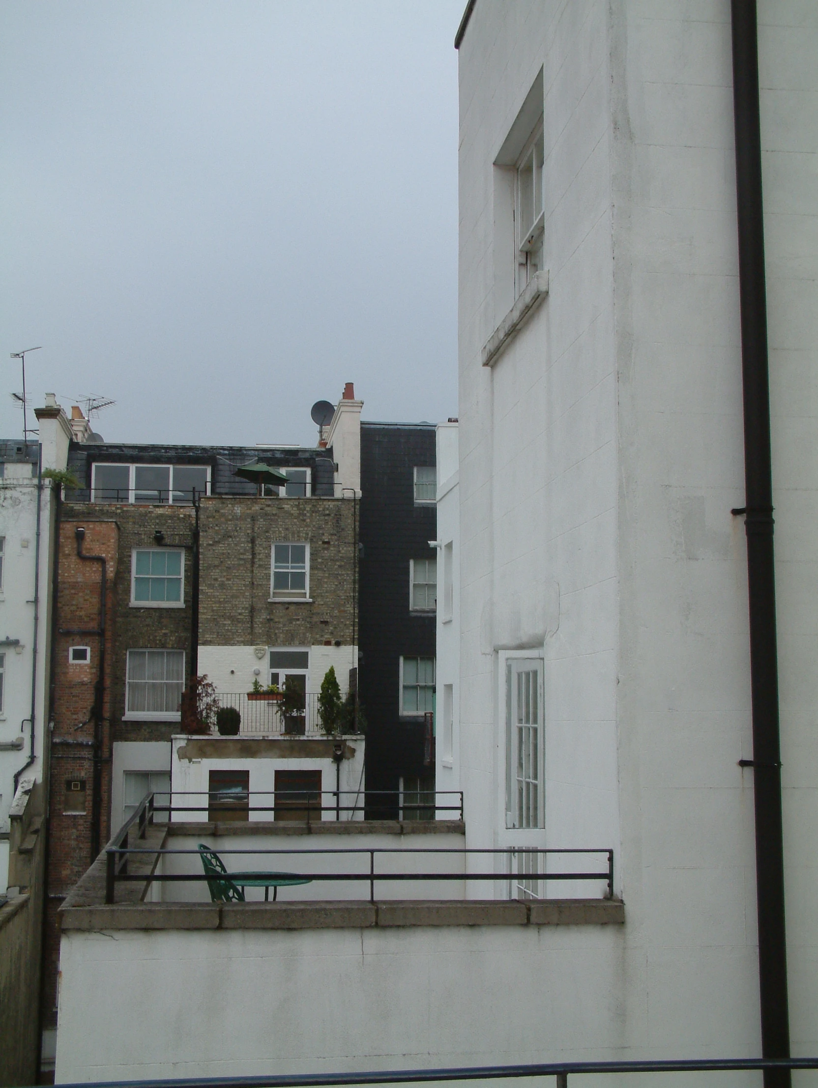 this is a building with a white roof and some buildings