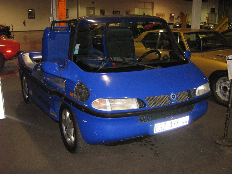 a blue car is parked near other cars