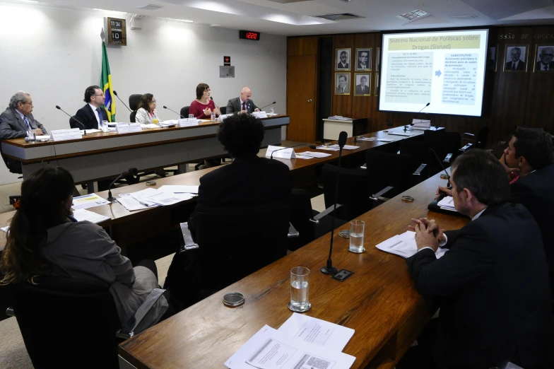 several people sitting at tables during a business meeting