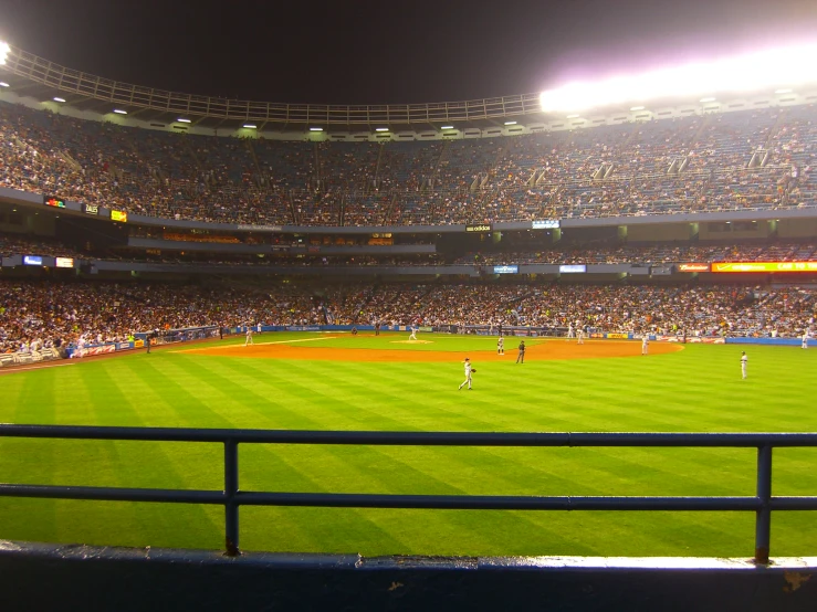 baseball stadium, full of fans at night, on a stormy day