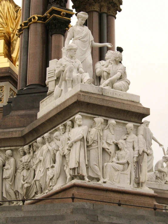 statues are in front of a tall pillar