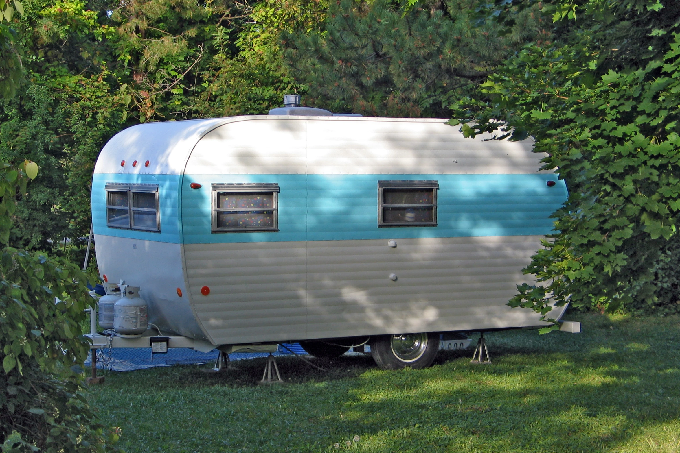 an old camper with a motor home in the woods